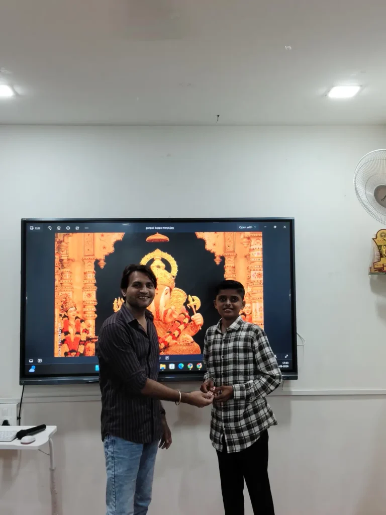 OnePlace student receiving a Ganpati festival games award