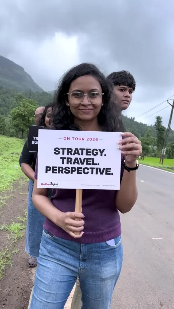 OnePlace student holding a Strategy Travel Perspective sign on the batch trip